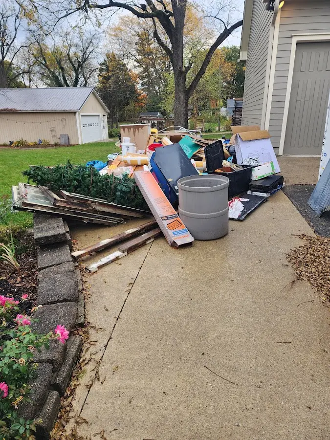 Dumpster being loaded with debris for Roofing Dumpster Rental in Weldon Spring